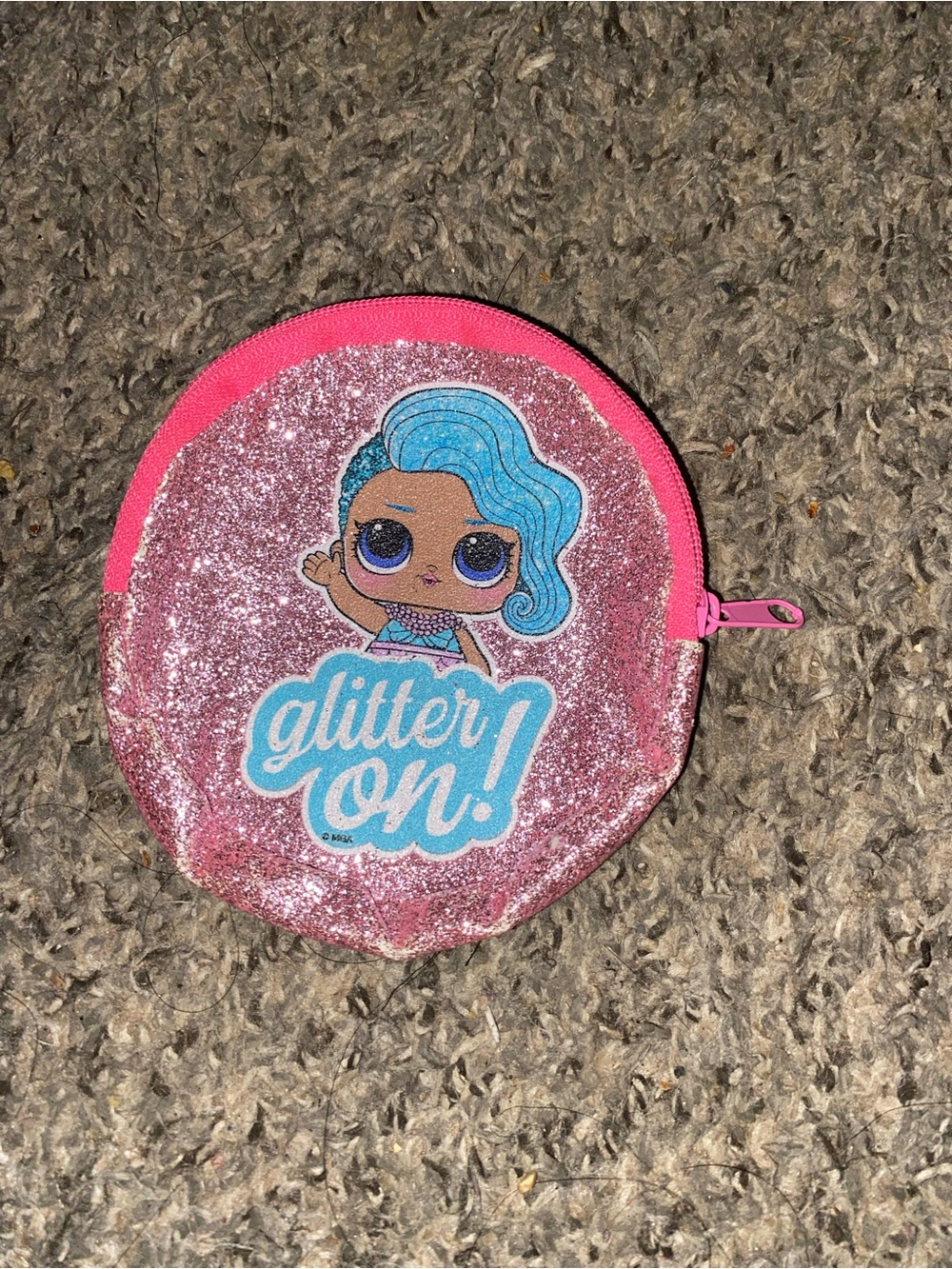 Pink glitter coin purse feature an L.O.L surprise